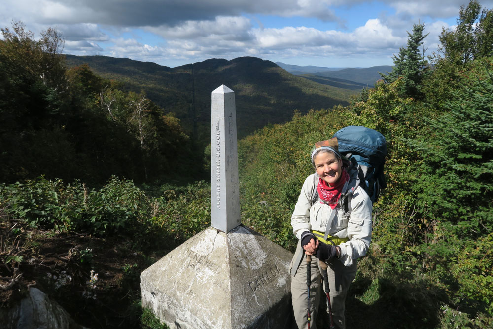 Dawn Chandler on the border of Vermont and Canada, having finally finished walking the last 100 miles of Vermont's Long Trail.