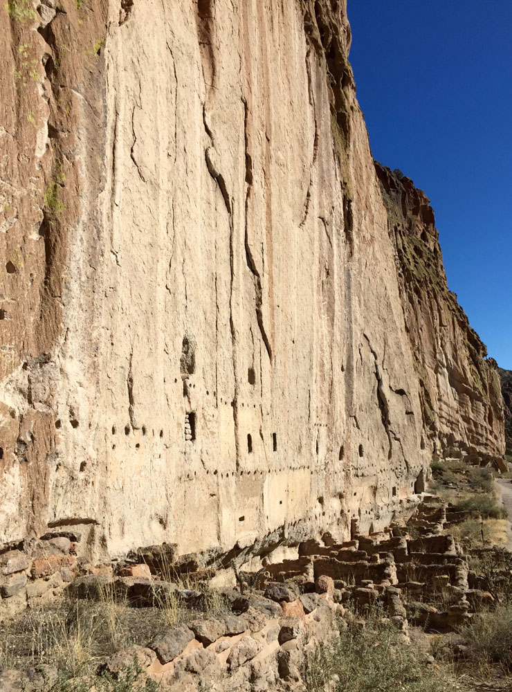The tall cliffs and dwellings of Bandelier National Monument, photographed by artist Dawn Chandler