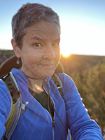 Artist Dawn Chandler pausing during a sunrise hike at the Galisteo Basin south of Santa Fe, New Mexico.