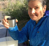 Artist Dawn Chandler enjoying coffee and journalling time by the Rio Grande.