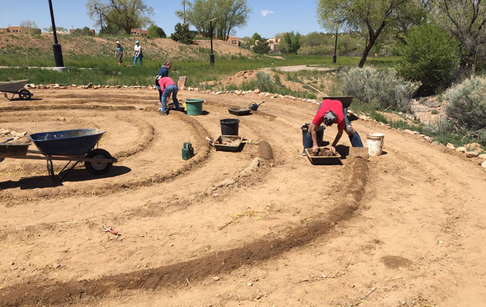 Volunteers working on remudding the Frenchy's Park labyrinth in Santa Fe. Photo by Dawn Chandler.