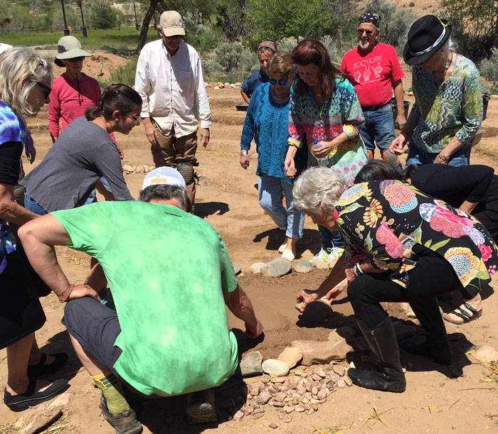 Neighbors gather stones to place around the earthen heart at the Frenchy's Park labyrinth in Santa Fe. Photo by Dawn Chandler.