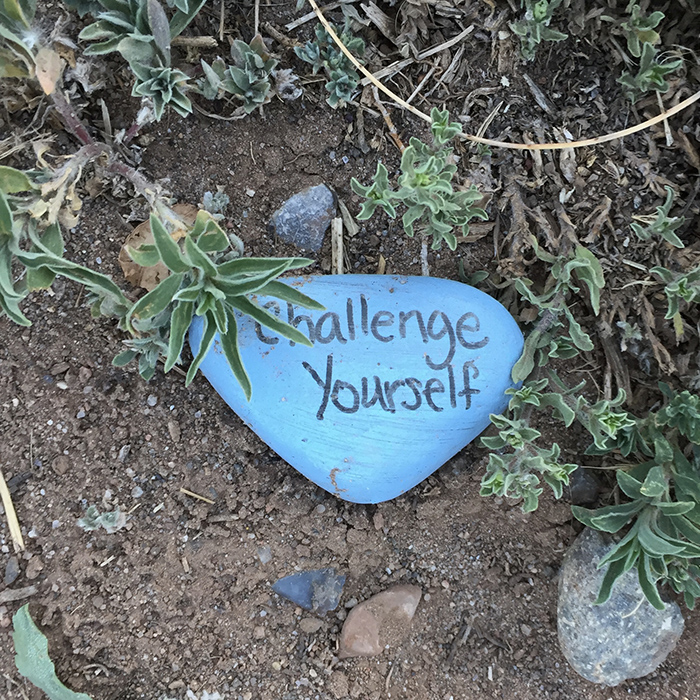 Challenge Yourself - Blue stone quotation art east side of the Sandias. Photo by Dawn Chandler.