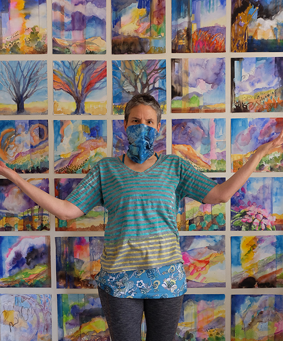 New Mexico artist Dawn Chandler proudly social distancing in her studio among her Watercolor Wanderings painting series.