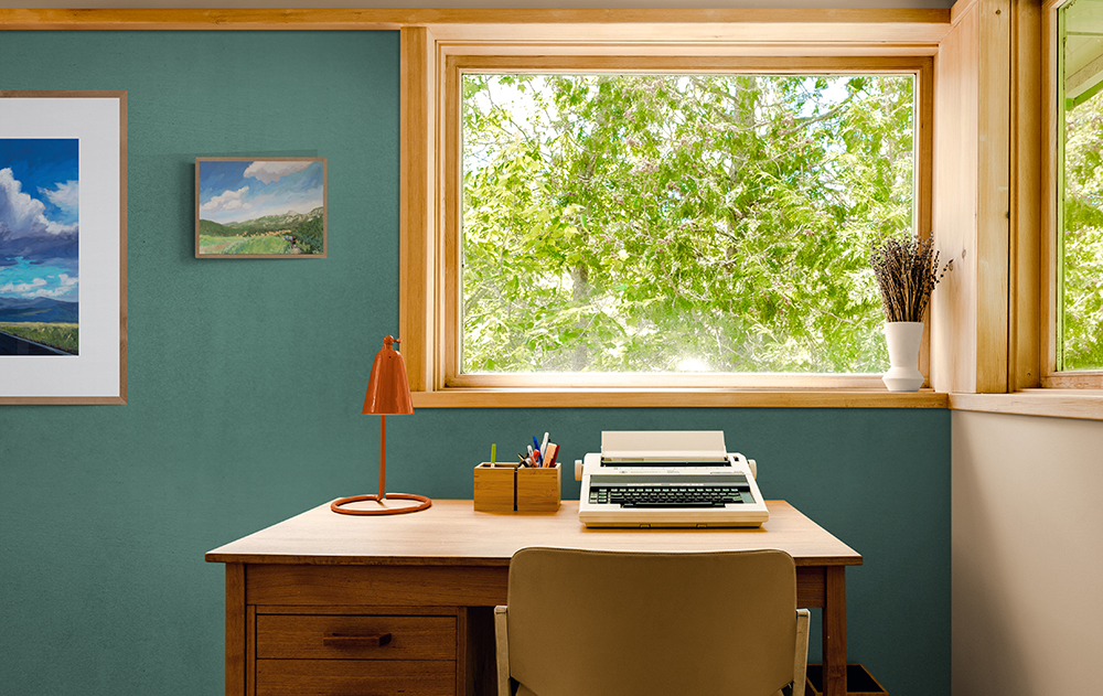 Room mock-up with Dawn Chandler's Philmont painting We All Made It framed on the wall.