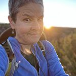 Artist Dawn Chandler pausing during a sunrise hike at the Galisteo Basin south of Santa Fe, New Mexico.