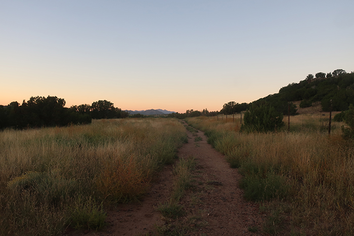 History and mystery in the New Mexico landscape: Mid-September, looking south at sunrise on the trail to the Cieneguilla petroglyphs. Photo by artist Dawn Chandler.