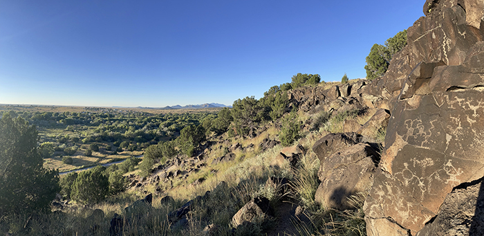 History and mystery in the New Mexico landscape: Looking out from the Cieneguilla petroglyphs to the distant Sandia Mountains. Photo by Dawn Chandler.