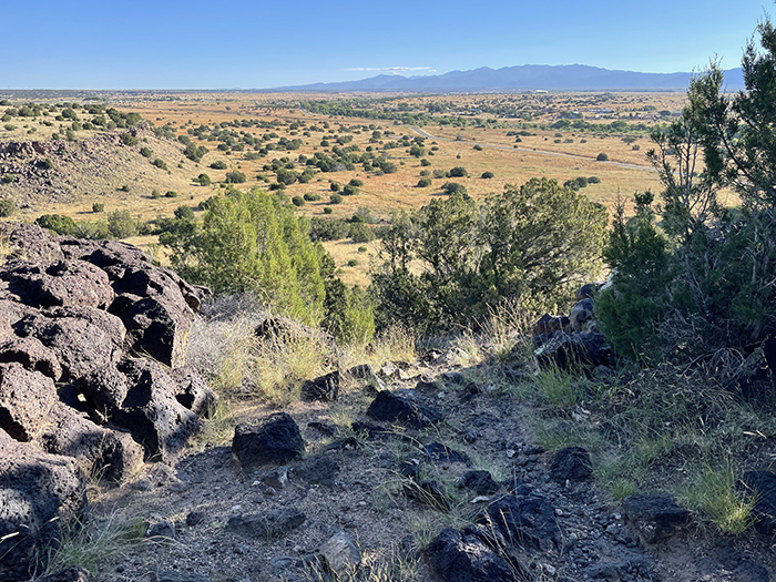 History and mystery in the New Mexico landscape: Mid-September, looking toward Santa Fe and the Sangre de Cristo Mountains from Cieneguilla in the Caja del Rio. Photo by Dawn Chandler.
