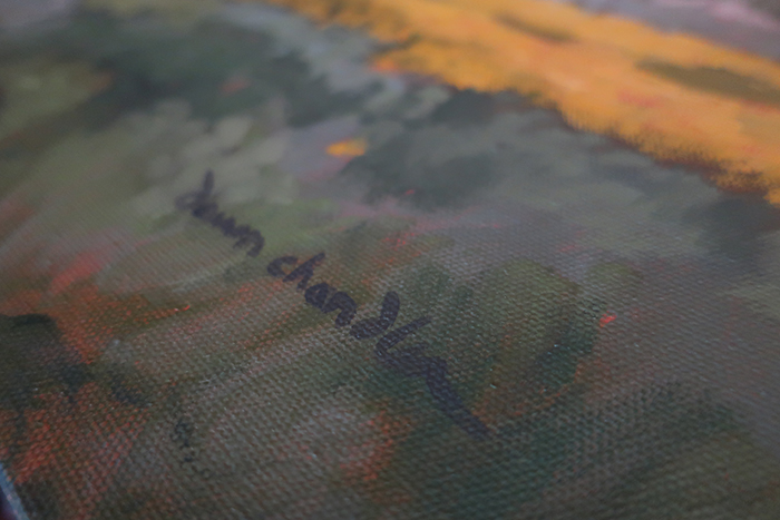 Signing a new painting.