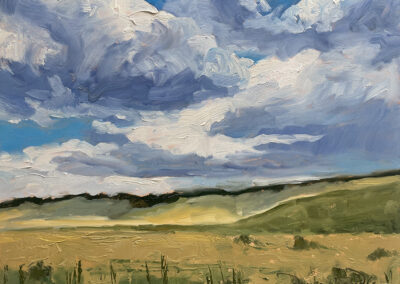 Under a High Country August Sky New Mexico landscape painting by artist Dawn Chandler of rolling August grasslands under a towering high‑country sky, with soft yellow‑green fields, distant dark hills, and sweeping blue and white storm clouds painted in loose, expressive brushstrokes.