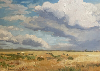 ‘Cloud Dance Over the Colfax Plains’ original New Mexico landscape painting in oil by Santa Fe artist Dawn Chandler, featuring a wide golden plain of Colfax County grasses under dramatic, billowing summer clouds filling the expansive blue sky.