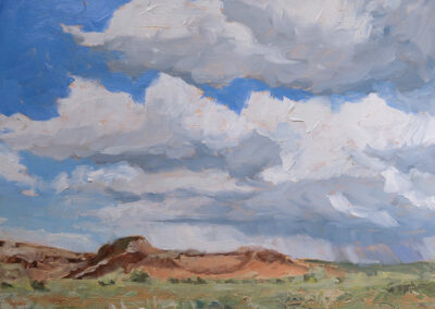 New Mexico landscape painting by artist Dawn Chandler of Ghost Ranch after the rain, with distant red and ochre cliffs rising above high desert fields under towering blue‑gray storm clouds and bright white cumulus clouds breaking open to patches of blue sky.