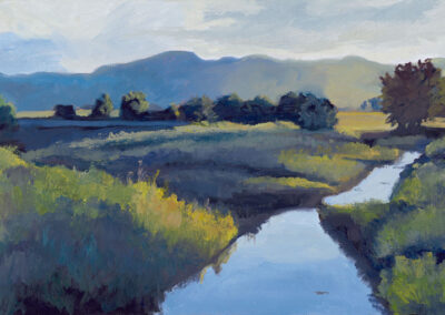 ‘June Evening on the Cimarron’ original New Mexico landscape painting in oil by Santa Fe artist Dawn Chandler, depicting the Cimarron River reflecting a pale evening sky as it winds through green meadow grasses and trees below soft blue mountains at Philmont.